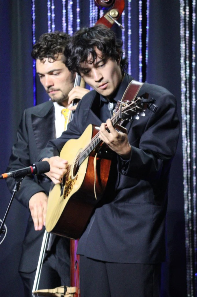 Guitar and bass on a dark stage